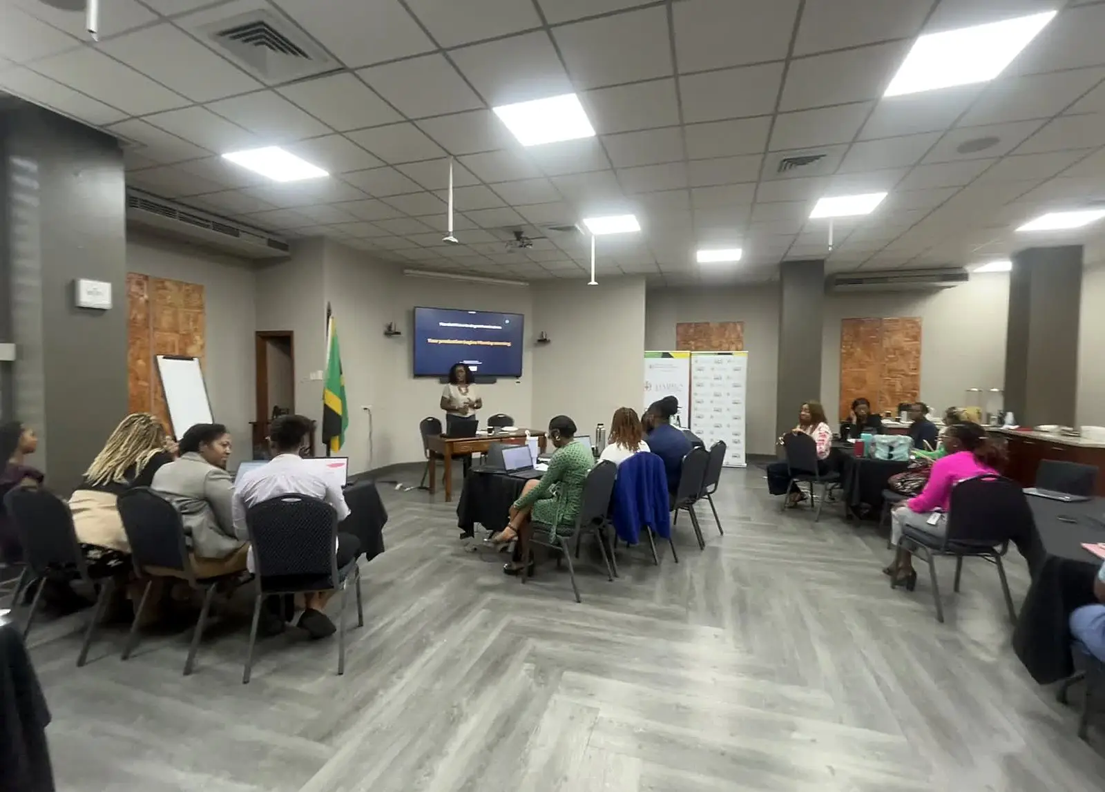 Professionals seated at round tables during a YAADBridge Workplace Intelligence workshop
